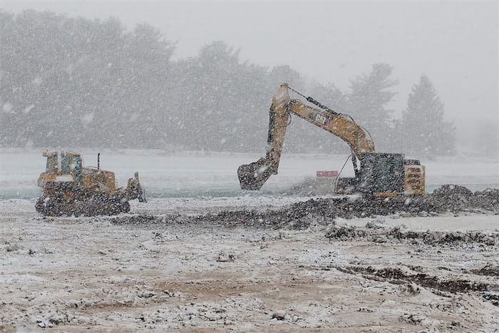 Excavators working in the snow